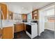 Galley style kitchen features wood cabinets, white counters, and black appliances at 1900 S Gilpin St, Denver, CO 80210