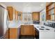 Bright kitchen with stainless appliances, wood cabinets, and a sunny window above the sink at 1900 S Gilpin St, Denver, CO 80210