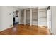 Bright room boasts hardwood floors and built in bookshelves, plus an entry to the kitchen at 1900 S Gilpin St, Denver, CO 80210