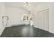 Living room with tiled floor, beamed ceiling, large window and a double door closet at 1900 S Gilpin St, Denver, CO 80210