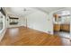 Open room showing hardwood floors, neutral paint, and access to the kitchen at 1900 S Gilpin St, Denver, CO 80210