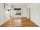 Bright living room with gleaming wood floors, clean white walls, and a large window bringing in natural light at 1900 S Gilpin St, Denver, CO 80210