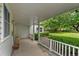 Covered porch with white railings, offering a peaceful outdoor space with views of the green yard at 1900 S Gilpin St, Denver, CO 80210