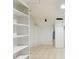 Storage area with built-in shelving, tiled floors, and access to mechanical systems at 1900 S Gilpin St, Denver, CO 80210