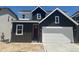 Modern two-story home featuring a gray exterior, a two-car garage, and a red front door at 13350 Blue Amber Ct, Parker, CO 80134
