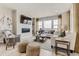Bright and airy living room with large windows, a fireplace, and stylish furniture at 13350 Blue Amber Ct, Parker, CO 80134