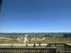 Scenic view showcasing a green landscape and neighborhood from a deck with wooden railings at 13350 Blue Amber Ct, Parker, CO 80134