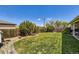 Expansive backyard with well-maintained grass and mature trees at 1475 Lucille Ct, Northglenn, CO 80233