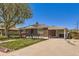 Charming brick home featuring a covered carport, manicured lawn, and mature trees at 1475 Lucille Ct, Northglenn, CO 80233