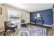 Inviting living room with elegant decor, featuring a striking blue accent wall and stylish seating arrangement at 1475 Lucille Ct, Northglenn, CO 80233
