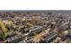 Aerial view showcasing a neighborhood with modern townhomes, lush green trees, and streets at 5880 W 39Th Pl, Wheat Ridge, CO 80212