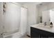 Clean bathroom featuring a shower/tub combo with a white curtain and a modern vanity at 5880 W 39Th Pl, Wheat Ridge, CO 80212