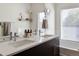 Close-up of bathroom with double vanity, quartz countertop, and ample natural light at 5880 W 39Th Pl, Wheat Ridge, CO 80212