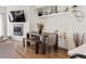 Stylish dining area with modern bench seating, a fireplace, and decorative shelving offering a cozy atmosphere at 5880 W 39Th Pl, Wheat Ridge, CO 80212
