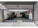 Spacious garage featuring an exercise bike, storage shelves, and bikes hanging on the back wall, offering ample space at 5880 W 39Th Pl, Wheat Ridge, CO 80212