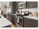 Modern kitchen with stainless steel appliances, white countertops and tile backsplash at 5880 W 39Th Pl, Wheat Ridge, CO 80212