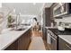 Open concept kitchen boasts stainless appliances, a spacious island and a view to the living area at 5880 W 39Th Pl, Wheat Ridge, CO 80212