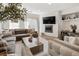 Bright living room with modern decor, a fireplace, and comfortable seating, perfect for relaxing at 5880 W 39Th Pl, Wheat Ridge, CO 80212