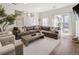 Bright living room features a comfortable sectional sofa, stylish decor, and access to an outdoor patio at 5880 W 39Th Pl, Wheat Ridge, CO 80212