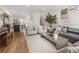Open-concept living space with modern furnishings, blending a comfortable seating area with an adjacent dining space at 5880 W 39Th Pl, Wheat Ridge, CO 80212