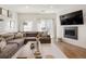 Stylish living room features a gray sectional sofa, modern fireplace, and plenty of natural light at 5880 W 39Th Pl, Wheat Ridge, CO 80212