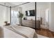 Well-lit bedroom with a four-poster bed, dresser, hardwood floors, and a large window at 5880 W 39Th Pl, Wheat Ridge, CO 80212