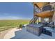 Large backyard patio with a hot tub, outdoor seating, and a view of the open fields, great for entertaining at 5923 S Jamestown Ct, Aurora, CO 80016