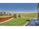 Well-maintained backyard with lush green grass, a fire pit, and a partial fence, creating a charming outdoor oasis at 5923 S Jamestown Ct, Aurora, CO 80016