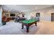 Spacious finished basement featuring a pool table, wet bar, and entertainment area for recreation and relaxation at 5923 S Jamestown Ct, Aurora, CO 80016
