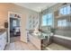 Bathroom featuring a tub, glass shower, and modern fixtures at 5923 S Jamestown Ct, Aurora, CO 80016