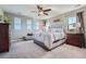 Primary bedroom with multiple windows offering natural light, a ceiling fan, and neutral decor at 5923 S Jamestown Ct, Aurora, CO 80016
