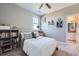 Bedroom featuring a full bookcase, neutral decor, and natural light at 5923 S Jamestown Ct, Aurora, CO 80016