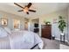 Bright bedroom featuring a ceiling fan, wood dresser, and decor at 5923 S Jamestown Ct, Aurora, CO 80016