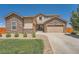 Charming two-story home with a stone and siding exterior and a well manicured lawn at 5923 S Jamestown Ct, Aurora, CO 80016