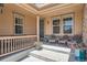 Inviting front porch with seating, decorative planters, and large windows at 5923 S Jamestown Ct, Aurora, CO 80016