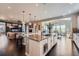 Bright eat-in kitchen with stainless appliances and center island overlooks the dining and living areas at 5923 S Jamestown Ct, Aurora, CO 80016