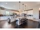 Bright, eat-in kitchen featuring a large center island with barstool seating, stainless appliances and pendant lighting at 5923 S Jamestown Ct, Aurora, CO 80016