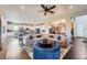 Spacious open-concept living area with a modern sectional sofa, ceiling fan and eat-in kitchen at 5923 S Jamestown Ct, Aurora, CO 80016