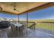 Relaxing covered outdoor deck complete with dining table, grill, and seating, perfect for enjoying outdoor meals at 5923 S Jamestown Ct, Aurora, CO 80016