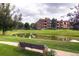 Scenic apartment view with a pond and lush greenery, creating a peaceful and picturesque setting at 2700 W Riverwalk Cir # C, Littleton, CO 80123