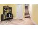 View of finished basement space with desk and chair near the stairway at 2700 W Riverwalk Cir # C, Littleton, CO 80123