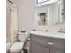 Bathroom featuring modern fixtures, vanity with marble countertop, and bathtub with showerhead at 2700 W Riverwalk Cir # C, Littleton, CO 80123