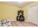 Bedroom with wood floors, yellow walls, and furniture at 2700 W Riverwalk Cir # C, Littleton, CO 80123