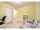 Bedroom with wood floors, yellow walls, and furniture at 2700 W Riverwalk Cir # C, Littleton, CO 80123