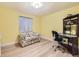 Bedroom with wood floors, yellow walls, and furniture at 2700 W Riverwalk Cir # C, Littleton, CO 80123