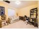 A cozy room with a comfortable floral couch, a desk and chair, and a unique wine rack at 2700 W Riverwalk Cir # C, Littleton, CO 80123
