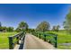 Picturesque wooden bridge over water on the golf course offers serene outdoor view at 2700 W Riverwalk Cir # C, Littleton, CO 80123