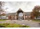 Inviting building exterior with peaked roof, glass entrance, and professionally landscaped grounds at 2700 W Riverwalk Cir # C, Littleton, CO 80123