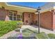 Inviting brick home entrance with colorful flowers and a seating area, creating a warm welcome at 2700 W Riverwalk Cir # C, Littleton, CO 80123