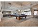 Spacious game room with pool tables, ping pong table, and comfortable seating area at 2700 W Riverwalk Cir # C, Littleton, CO 80123
